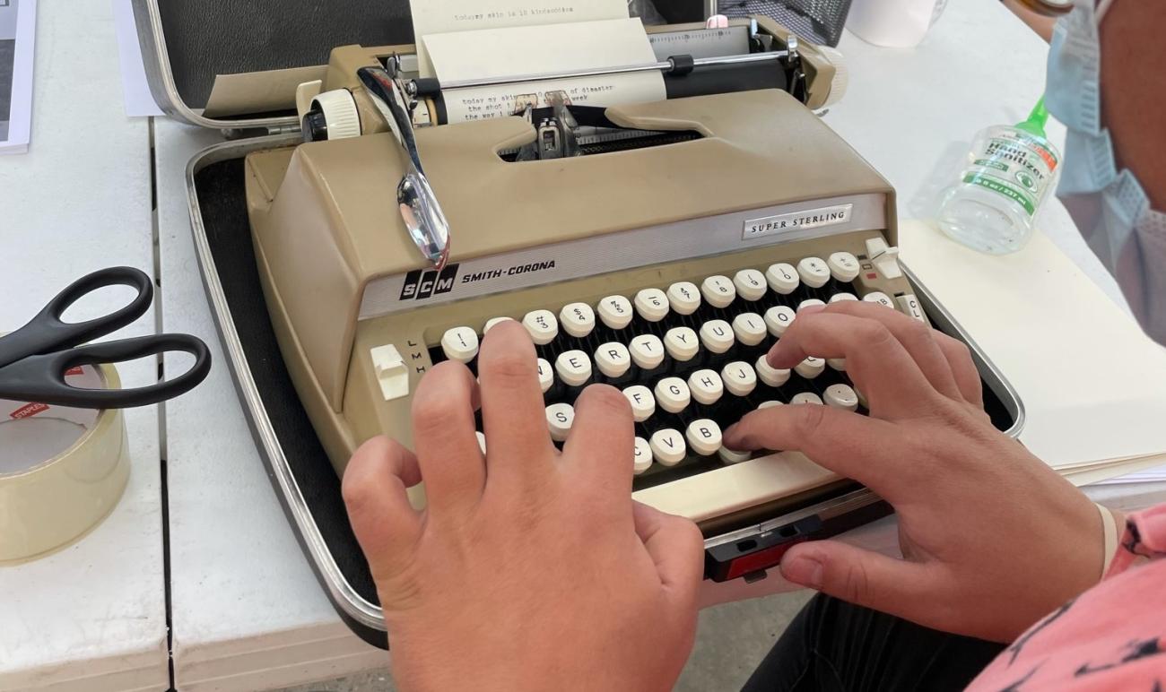 A person using a type writer.